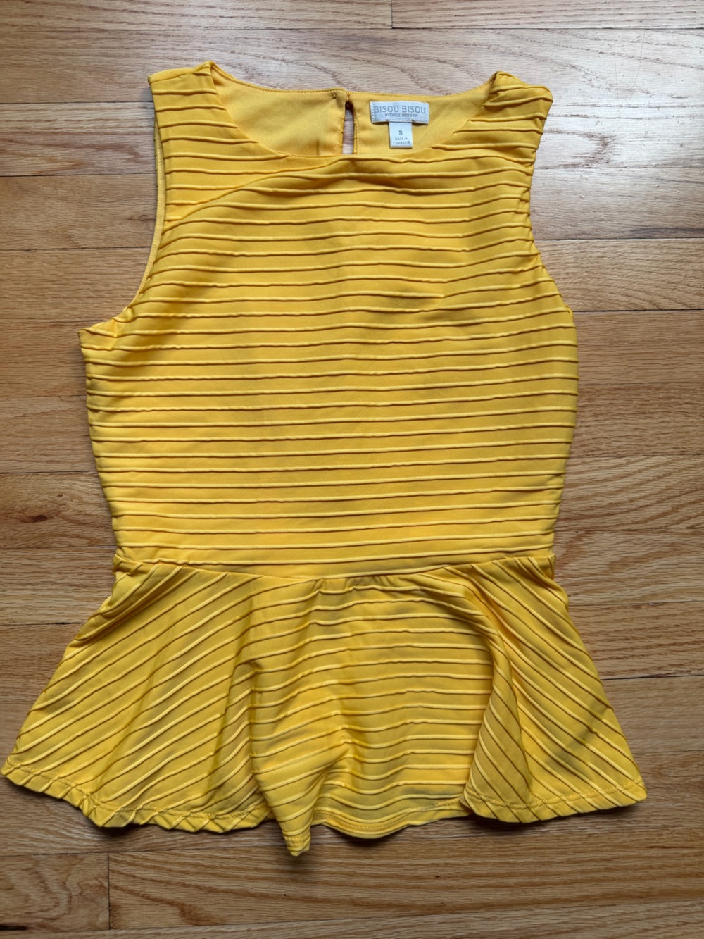 Bisou Bisou yellow peplum top with vertical pleated stripes